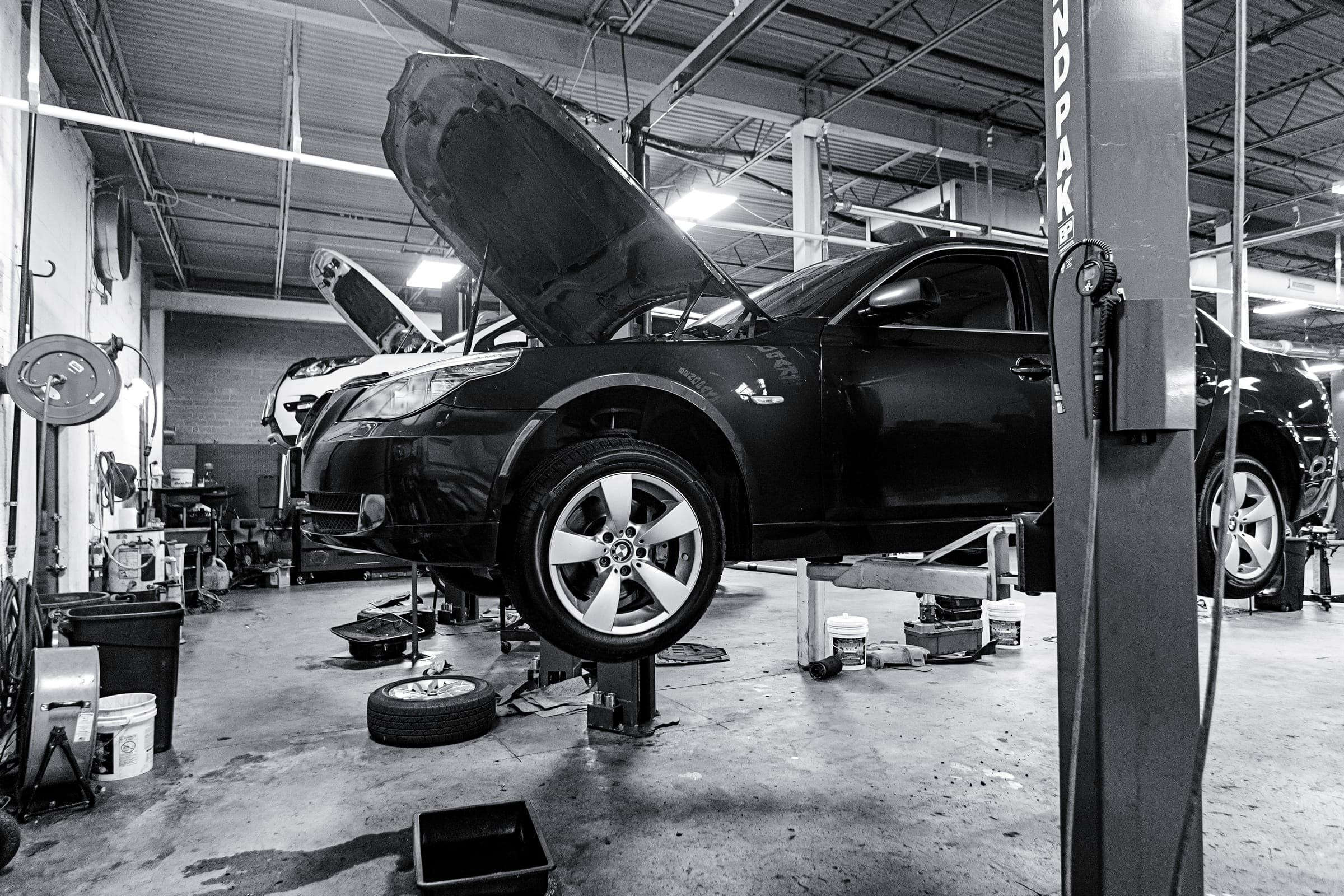 Blue BMW 5-Series in for oil leak repair at Eurowise