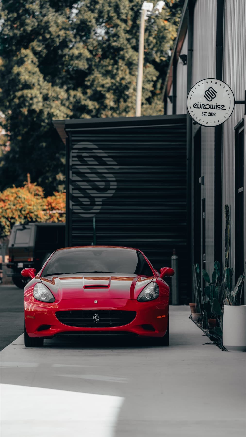Red Ferrari California outside the shop