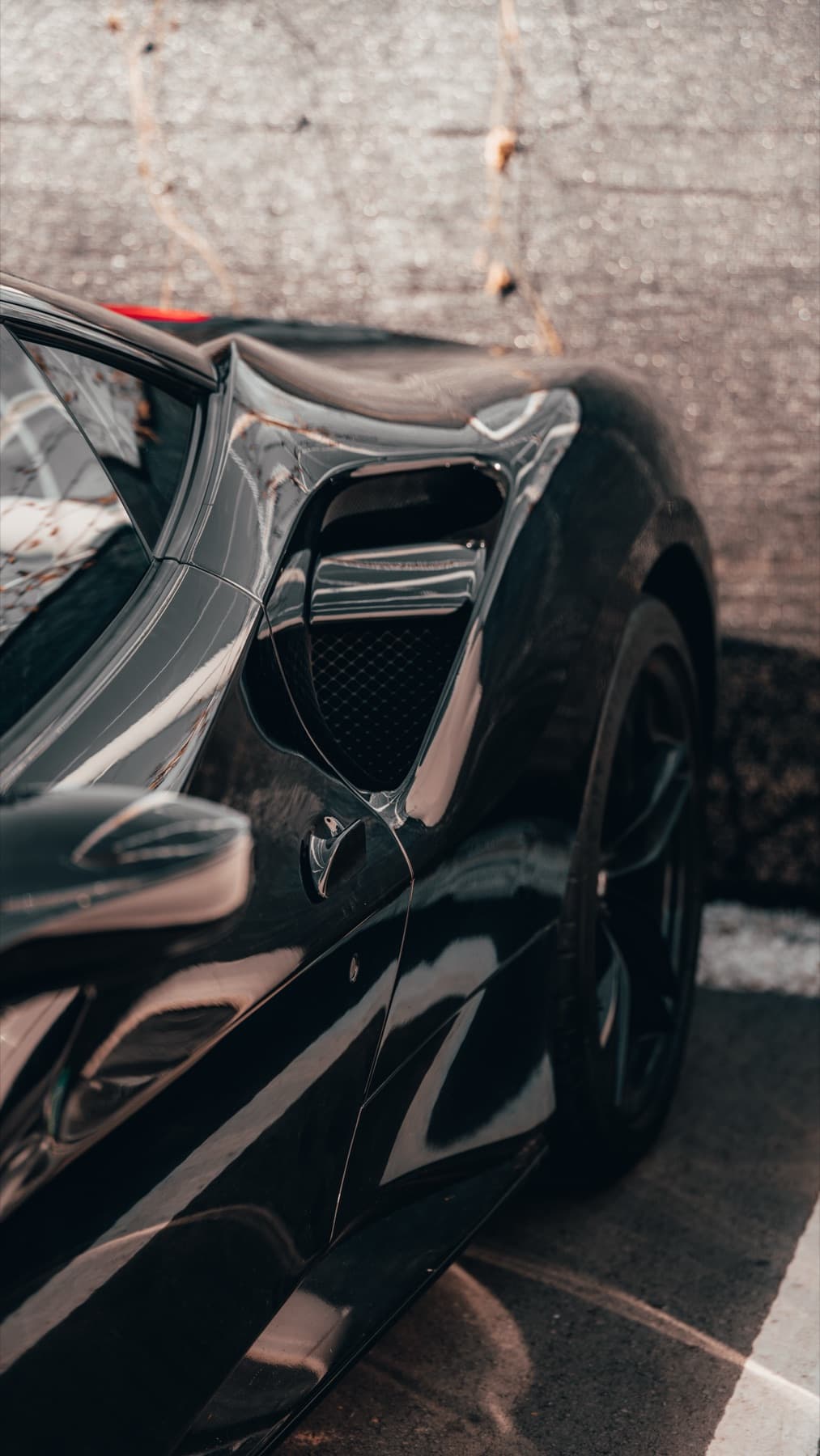 Rear wing detail on a black sports car