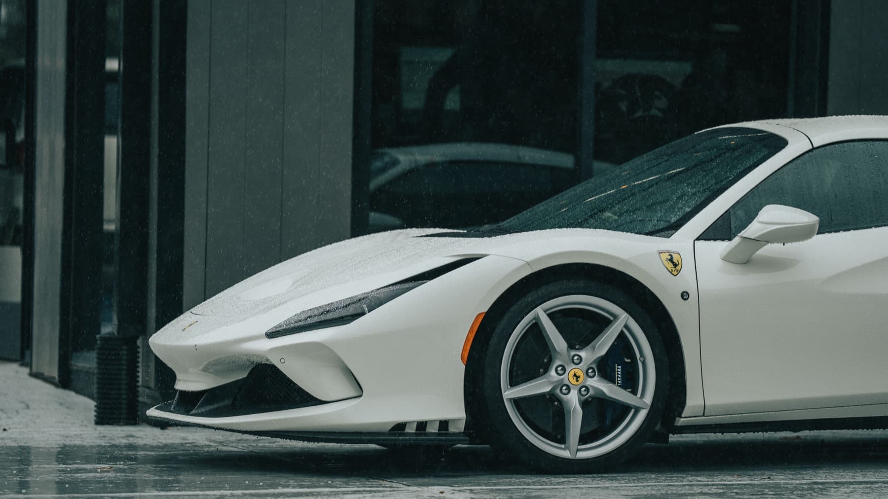 White Ferrari in profile outside the shop
