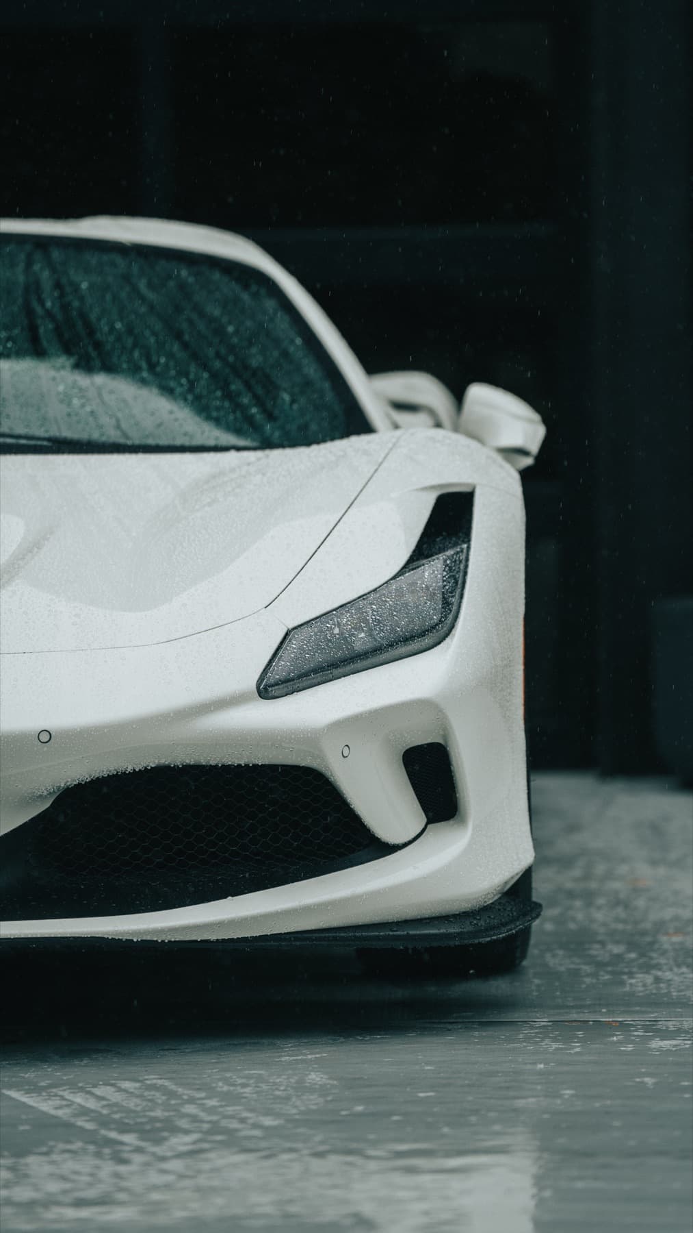 Rear three-quarter view of a white Ferrari