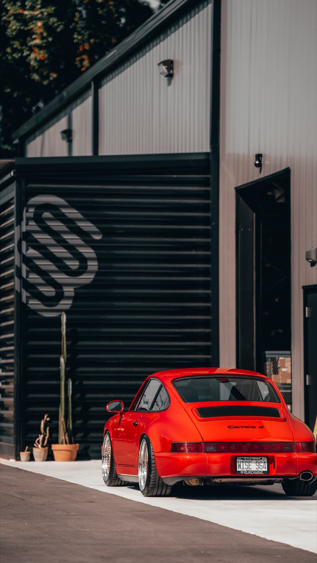 Orange Porsche 911 outside the Eurowise service bays