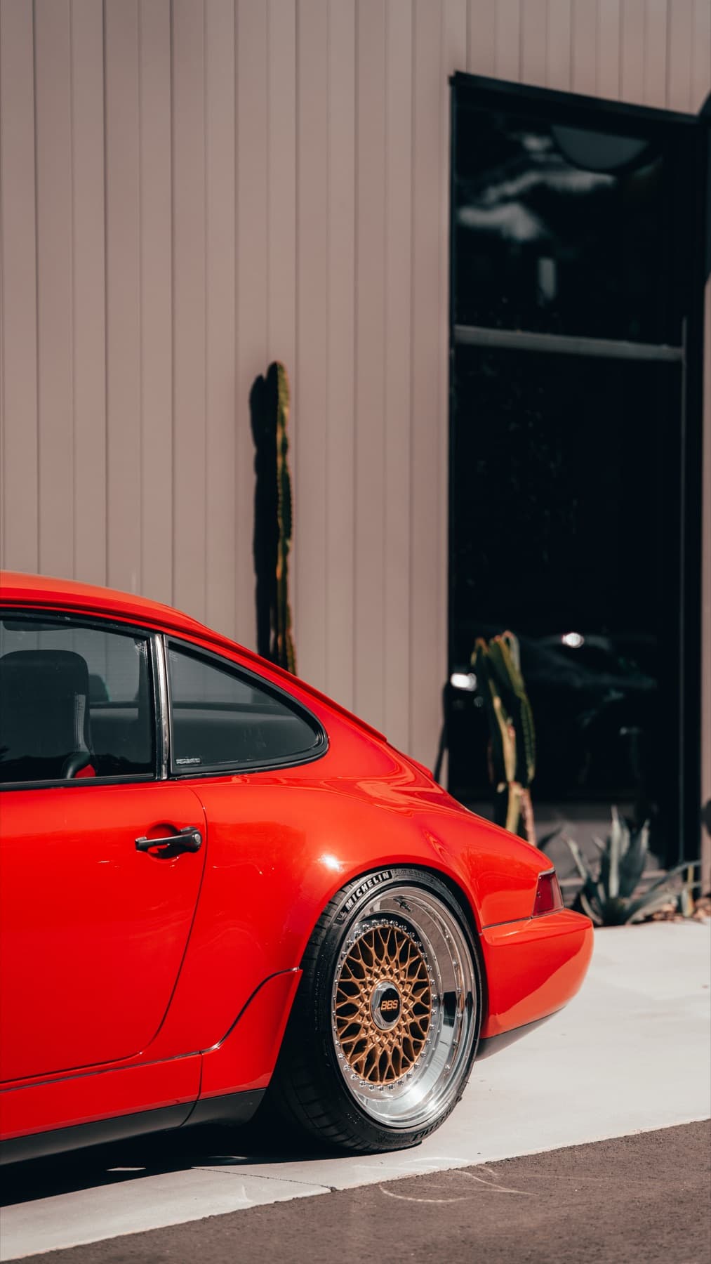 Orange Porsche 911 outside the shop
