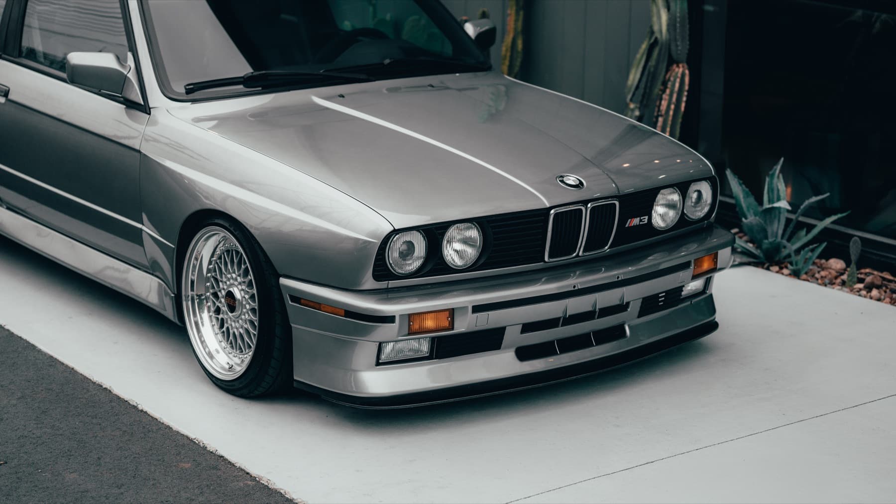 Front three-quarter view of a silver BMW E30 M3