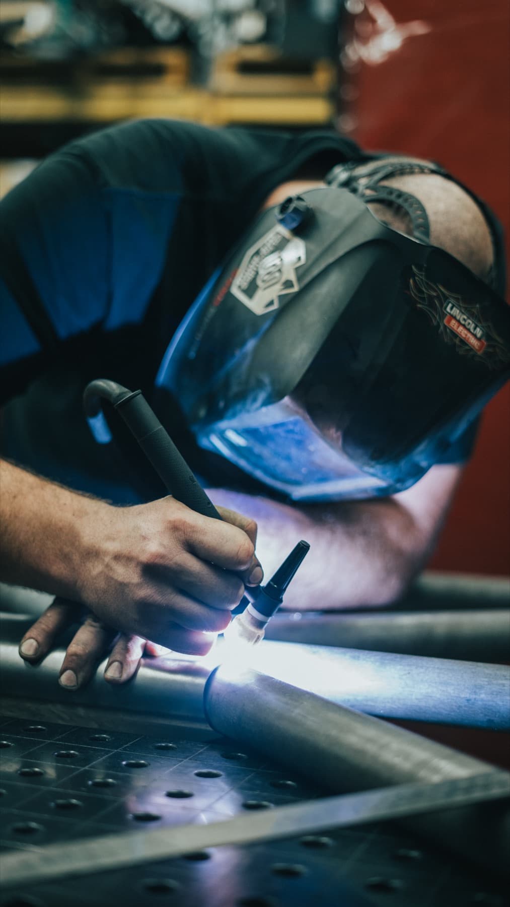 Fabricator in a welding helmet at work