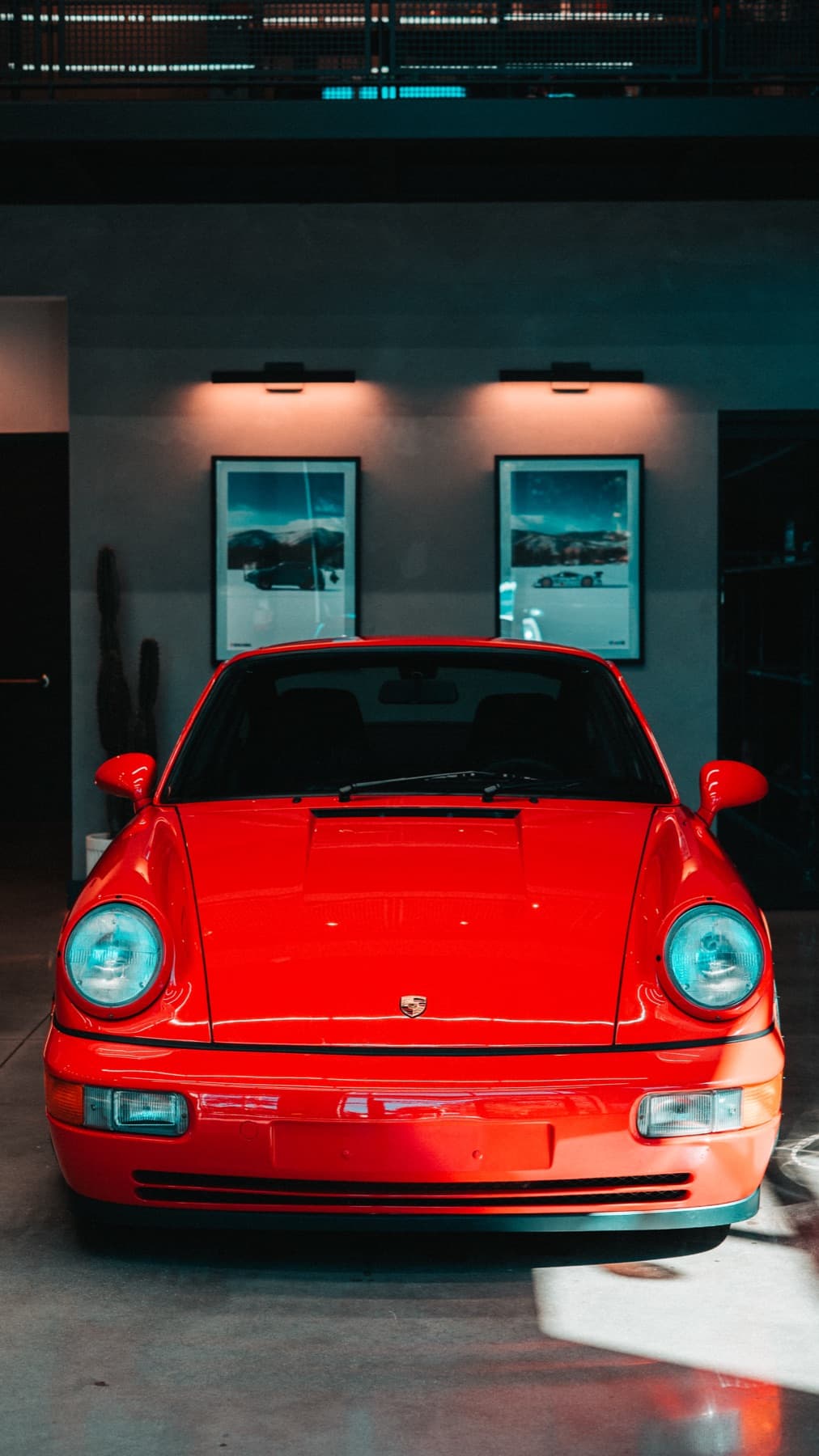 Front of an orange classic Porsche 911 in the showroom
