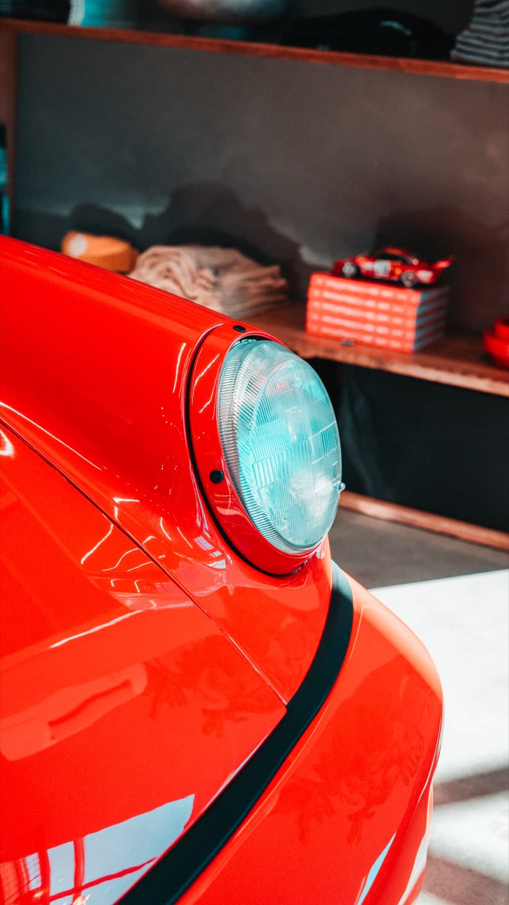 Headlight detail on an orange Porsche 911