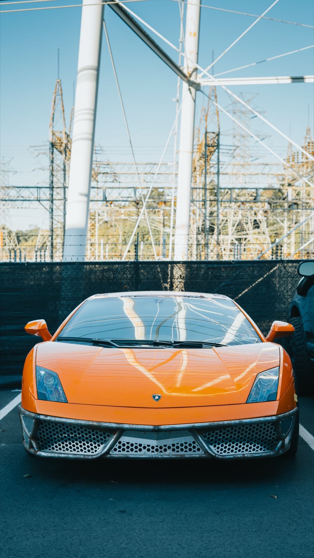 Orange sports car outside the shop