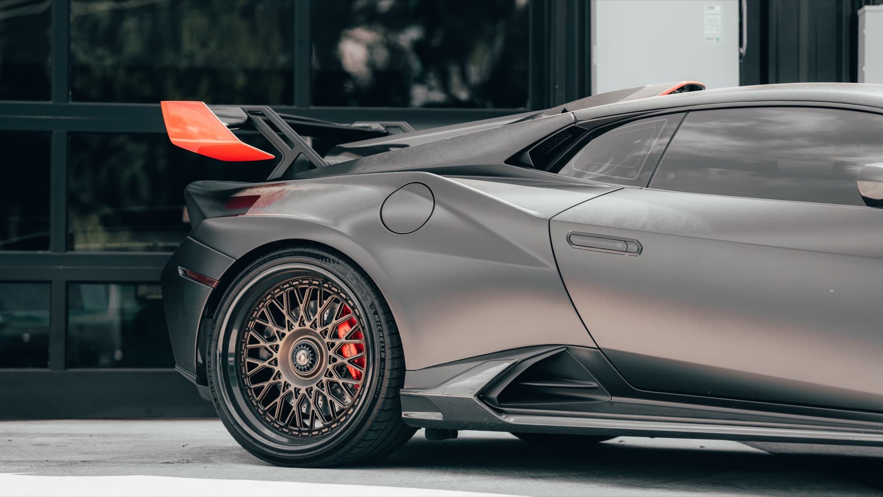 Grey Lamborghini Huracán STO outside the shop