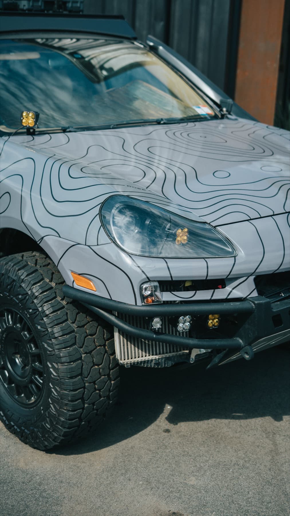 Front of a camouflage-wrapped Porsche