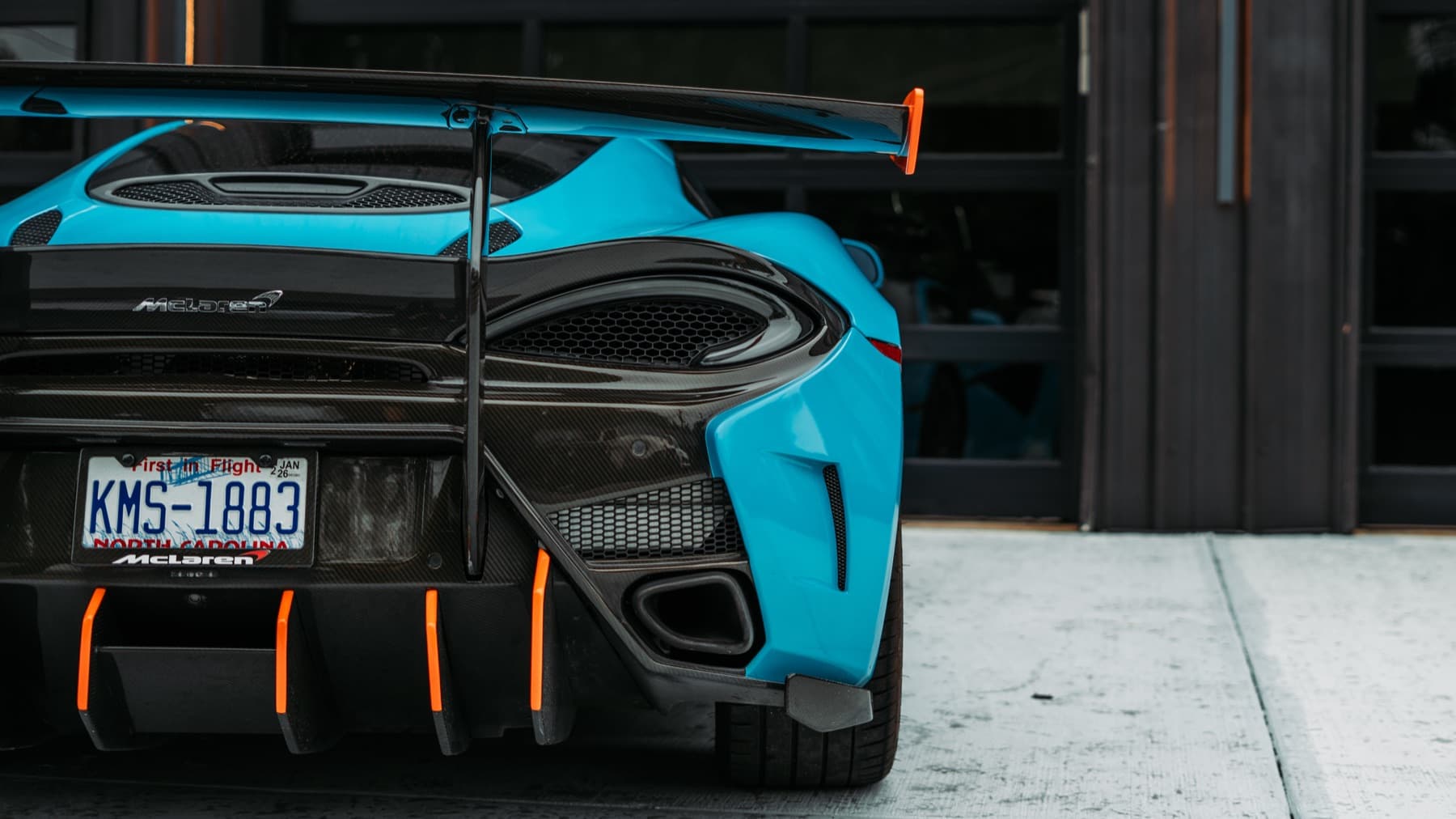 Rear of a light blue McLaren with a large wing