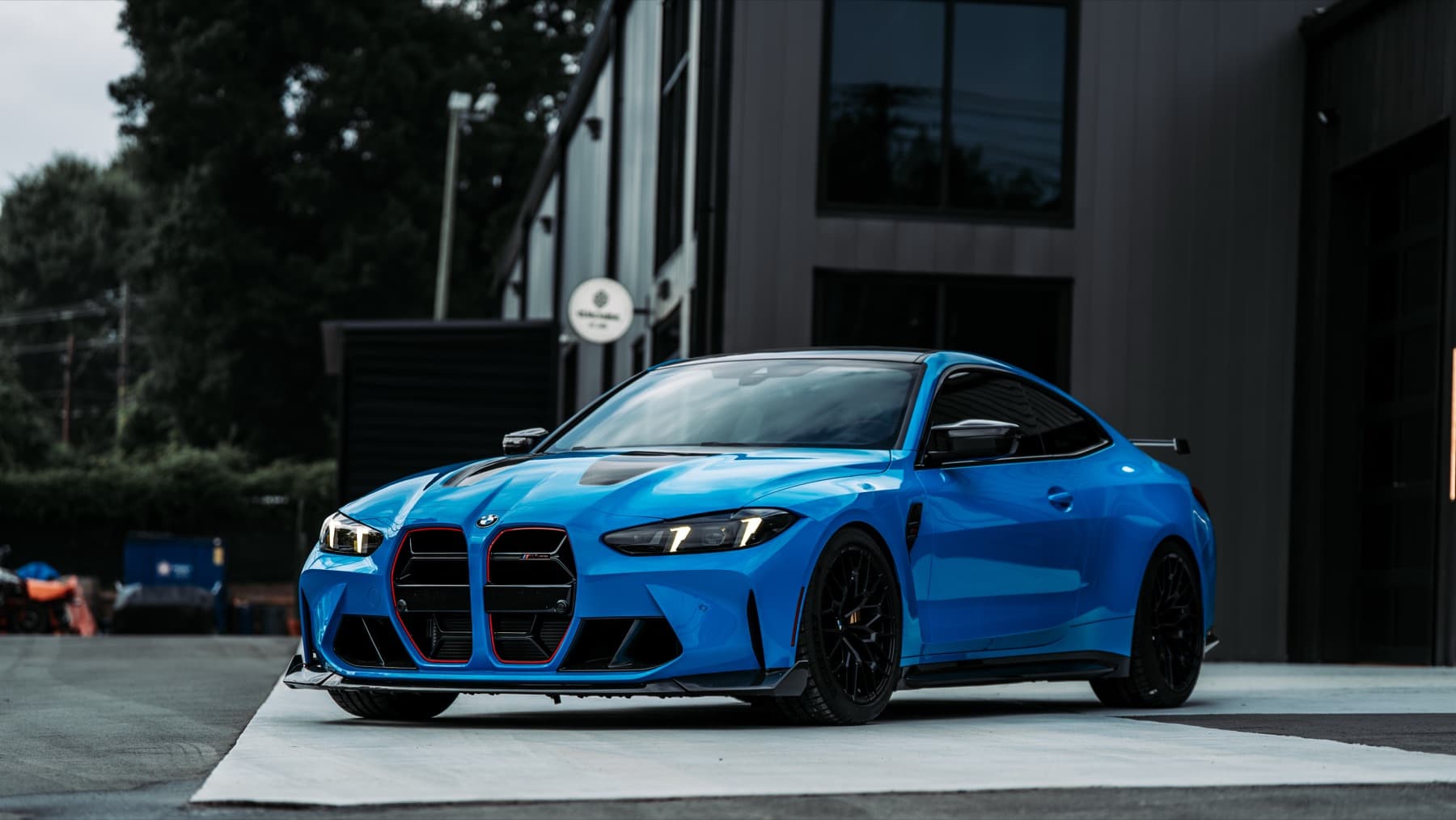 Blue BMW M4 outside the Eurowise building