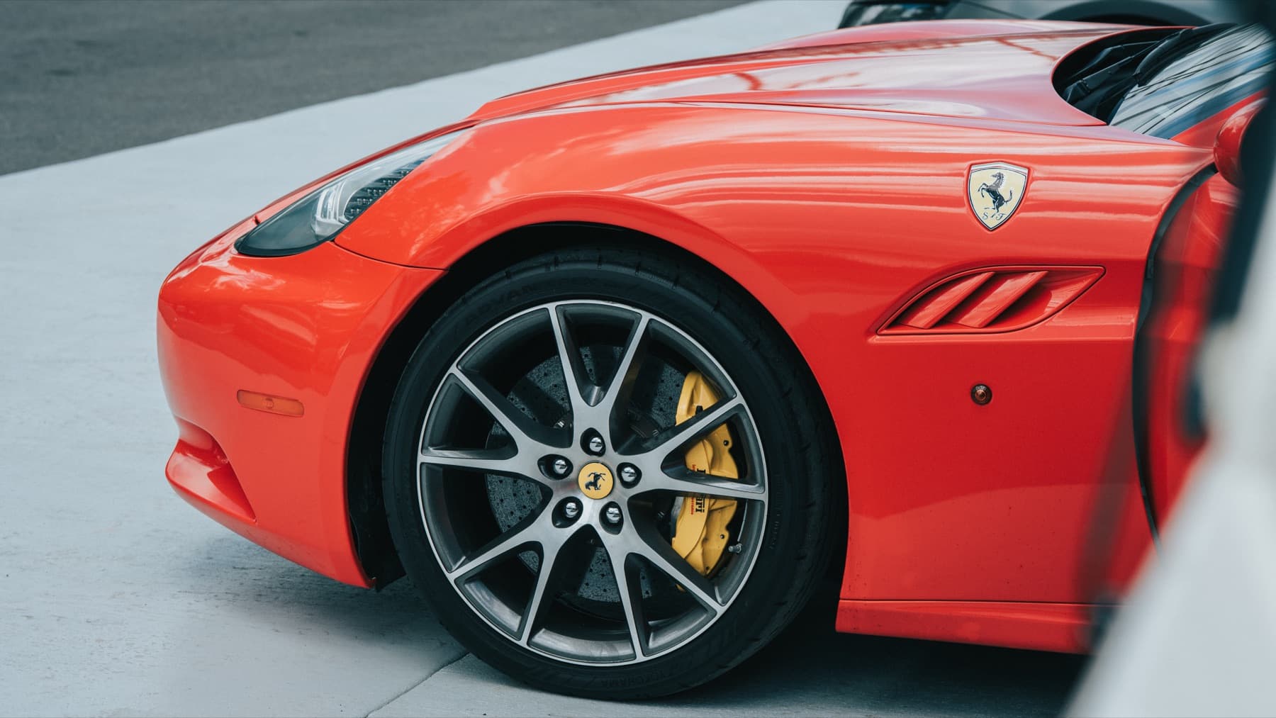 Wheel and yellow caliper on an orange Porsche