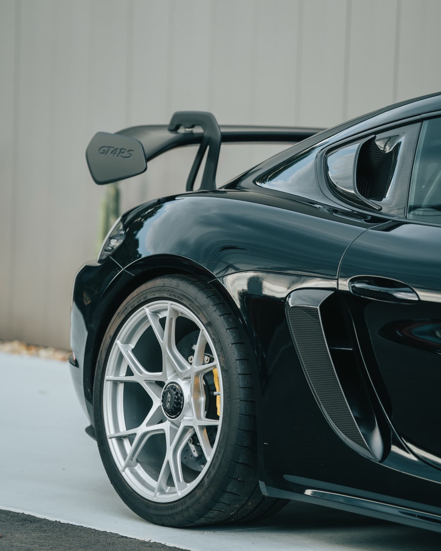 Rear wing on a black Porsche Cayman GT4
