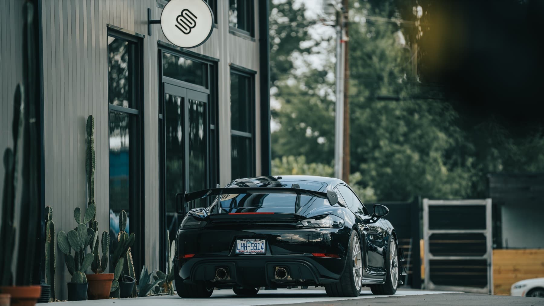 Black Porsche outside the Eurowise building