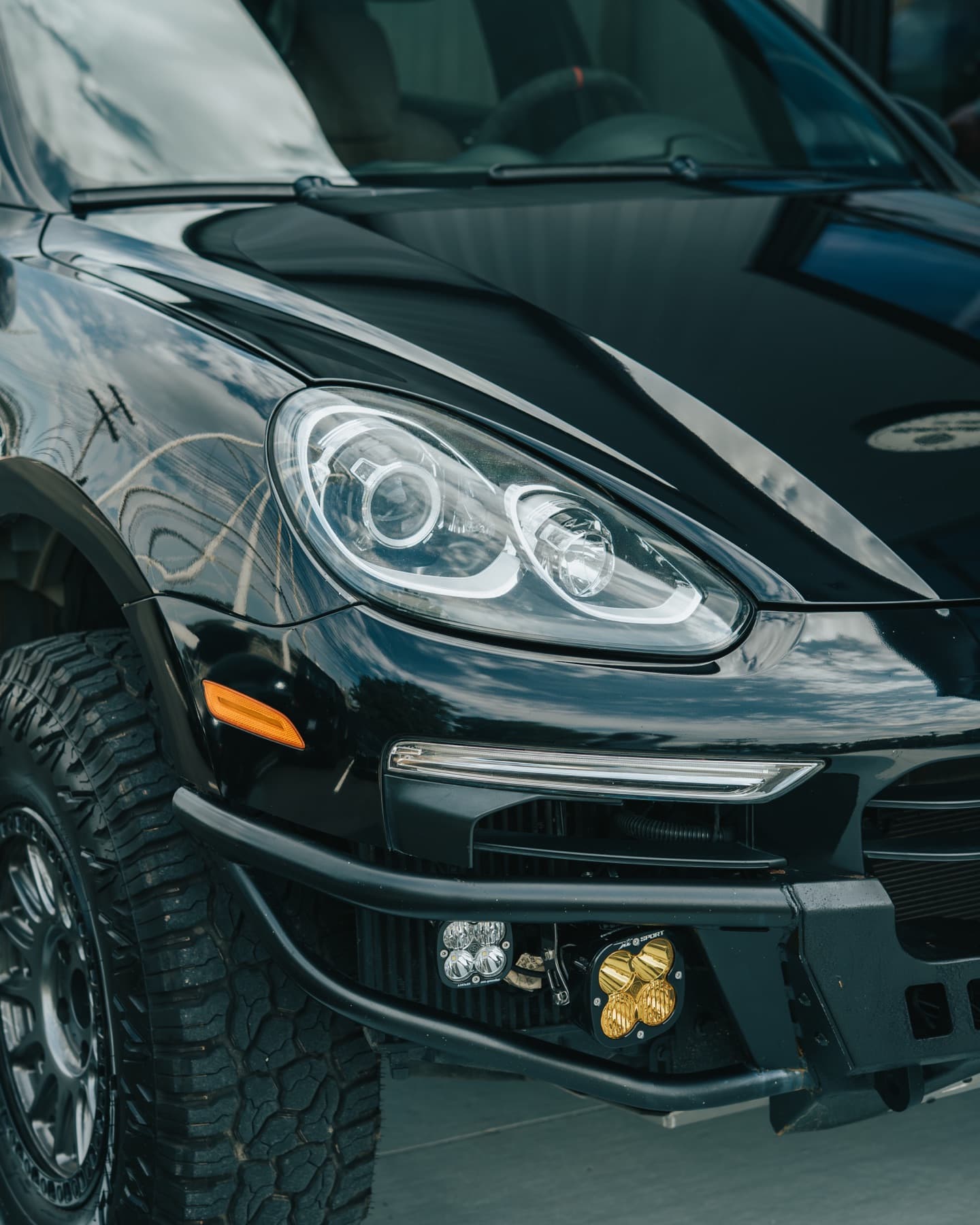 Headlight detail on a black Porsche Cayenne