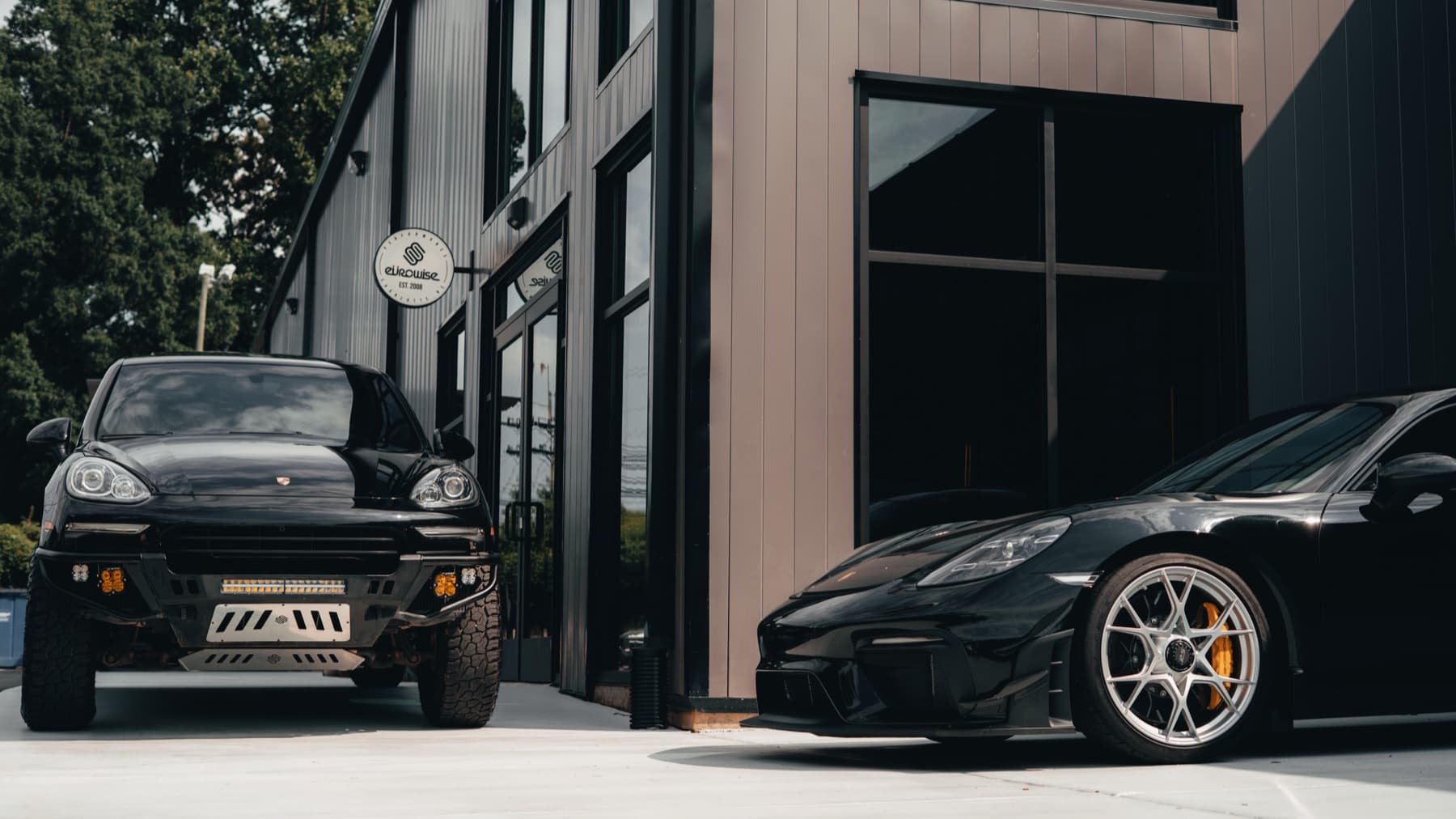Two black Porsches outside the Eurowise building