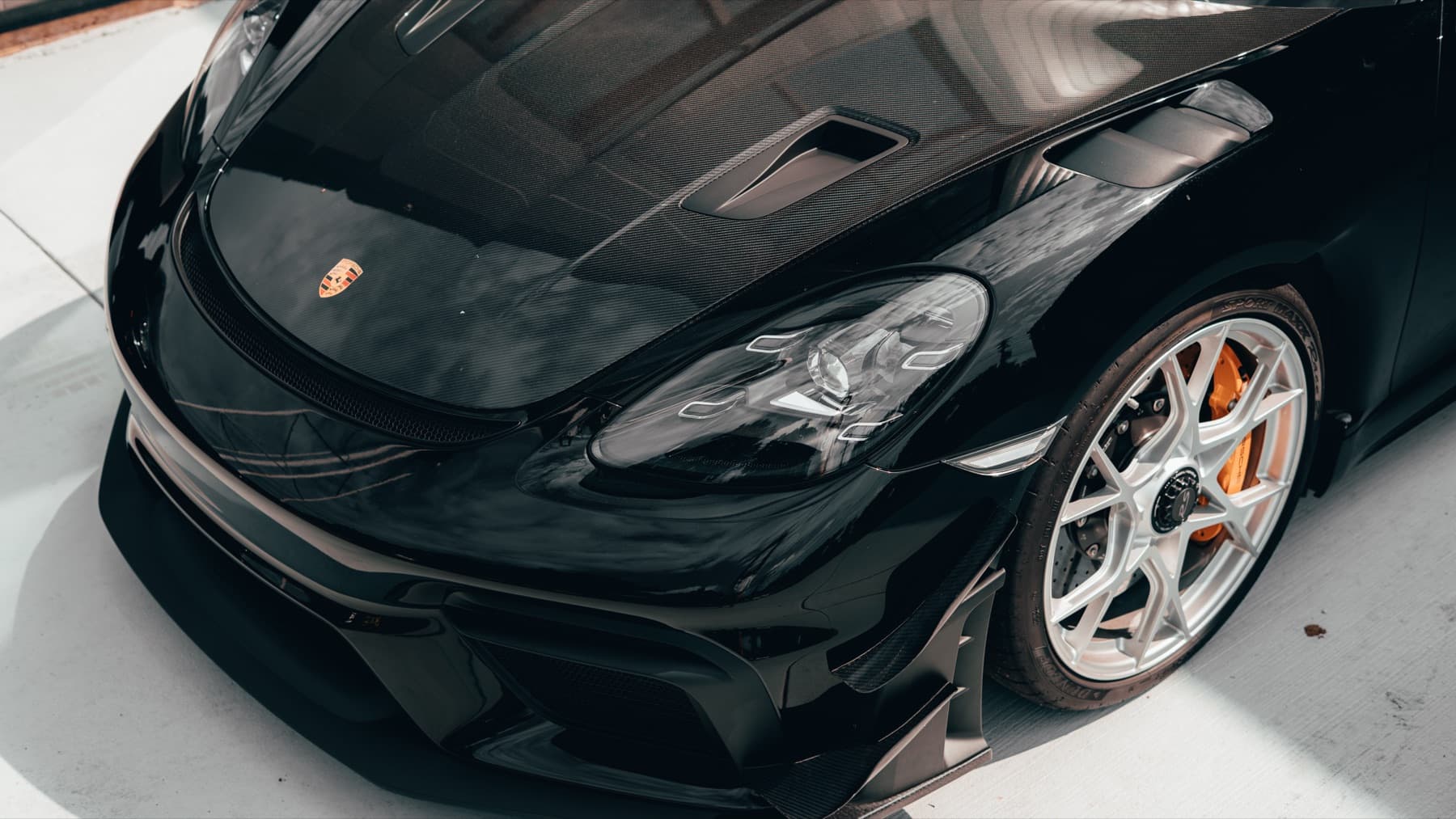 Front of a black Porsche 911 with its hood open