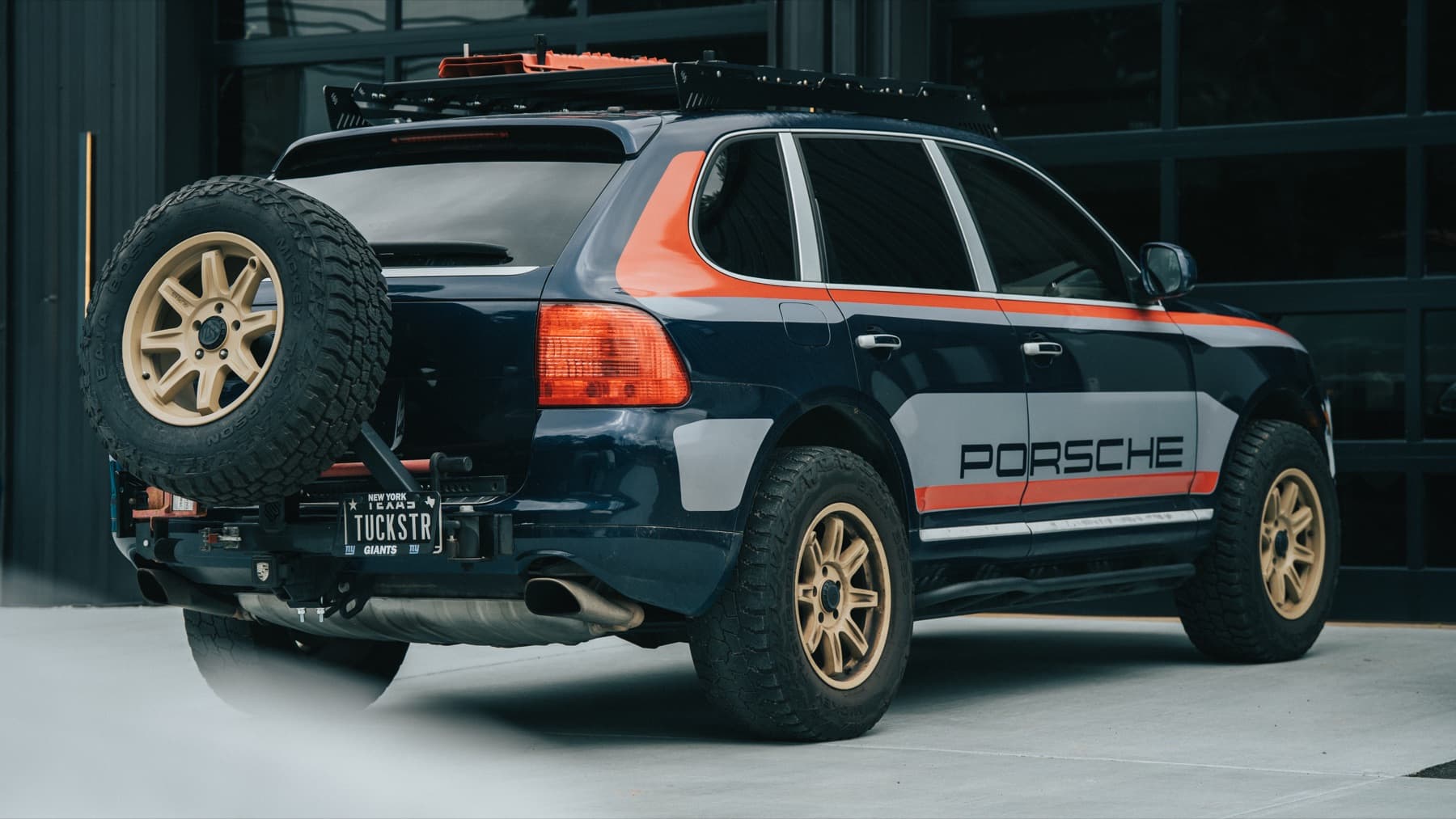 Rear of a Porsche Cayenne in rally livery