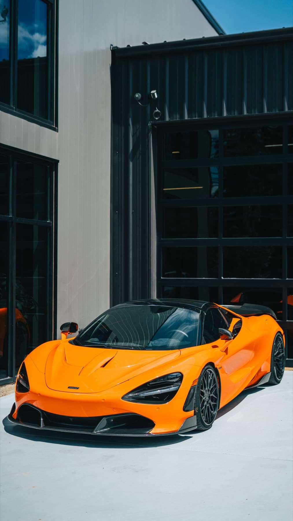 Orange McLaren 720S outside the shop