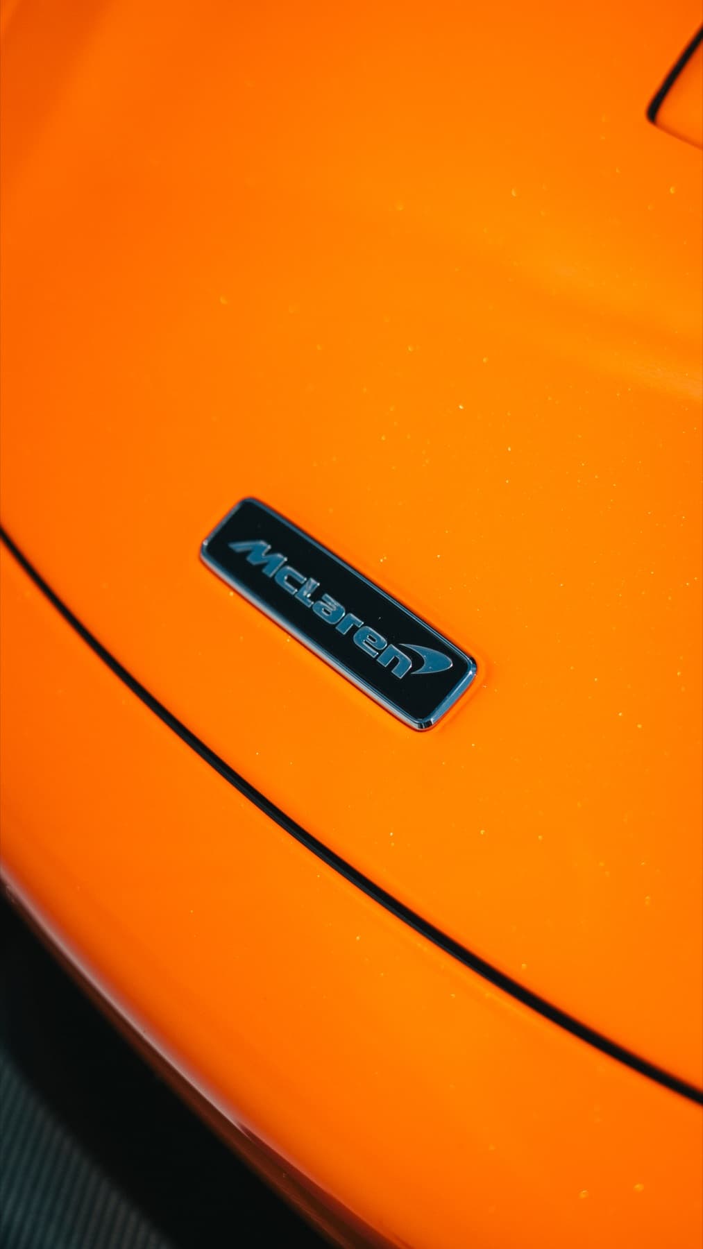 Badge detail on an orange McLaren 720S