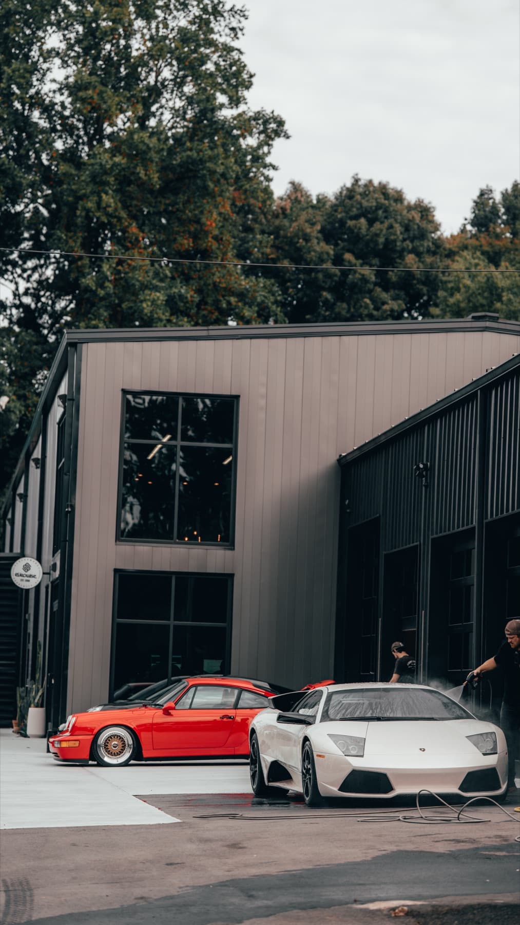 Orange Porsche 911 outside the Eurowise building