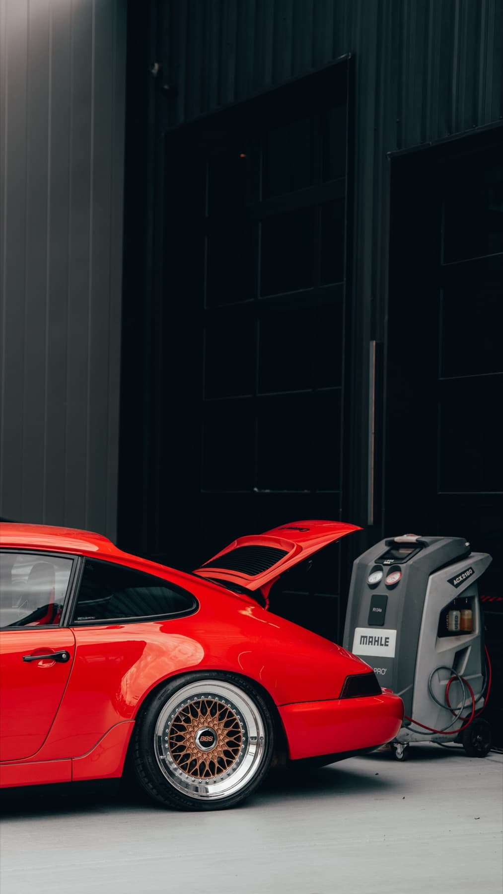 Orange Porsche 911 with its engine lid open