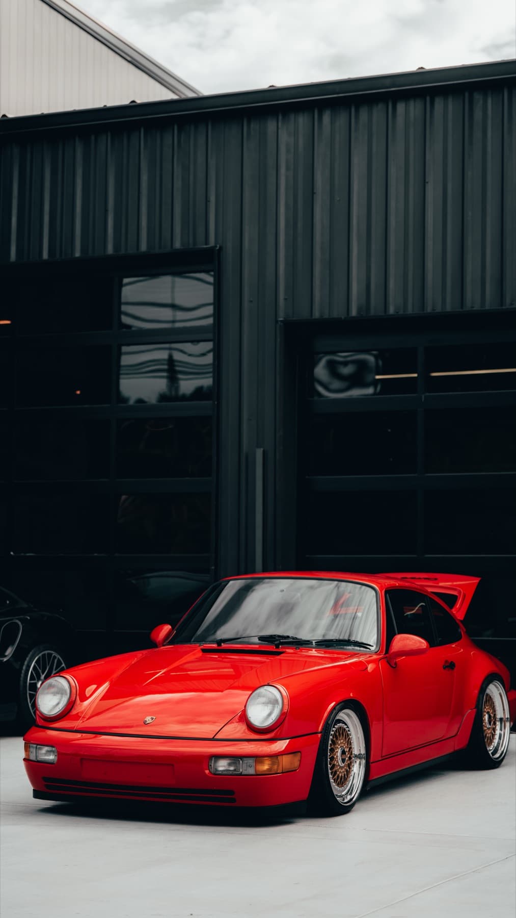 Orange Porsche 911 outside the shop