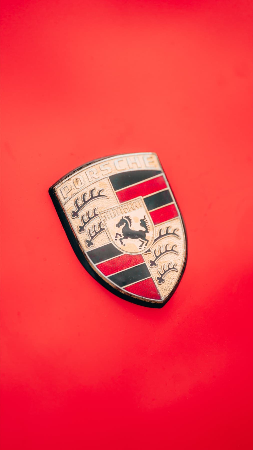 Porsche crest on an orange hood