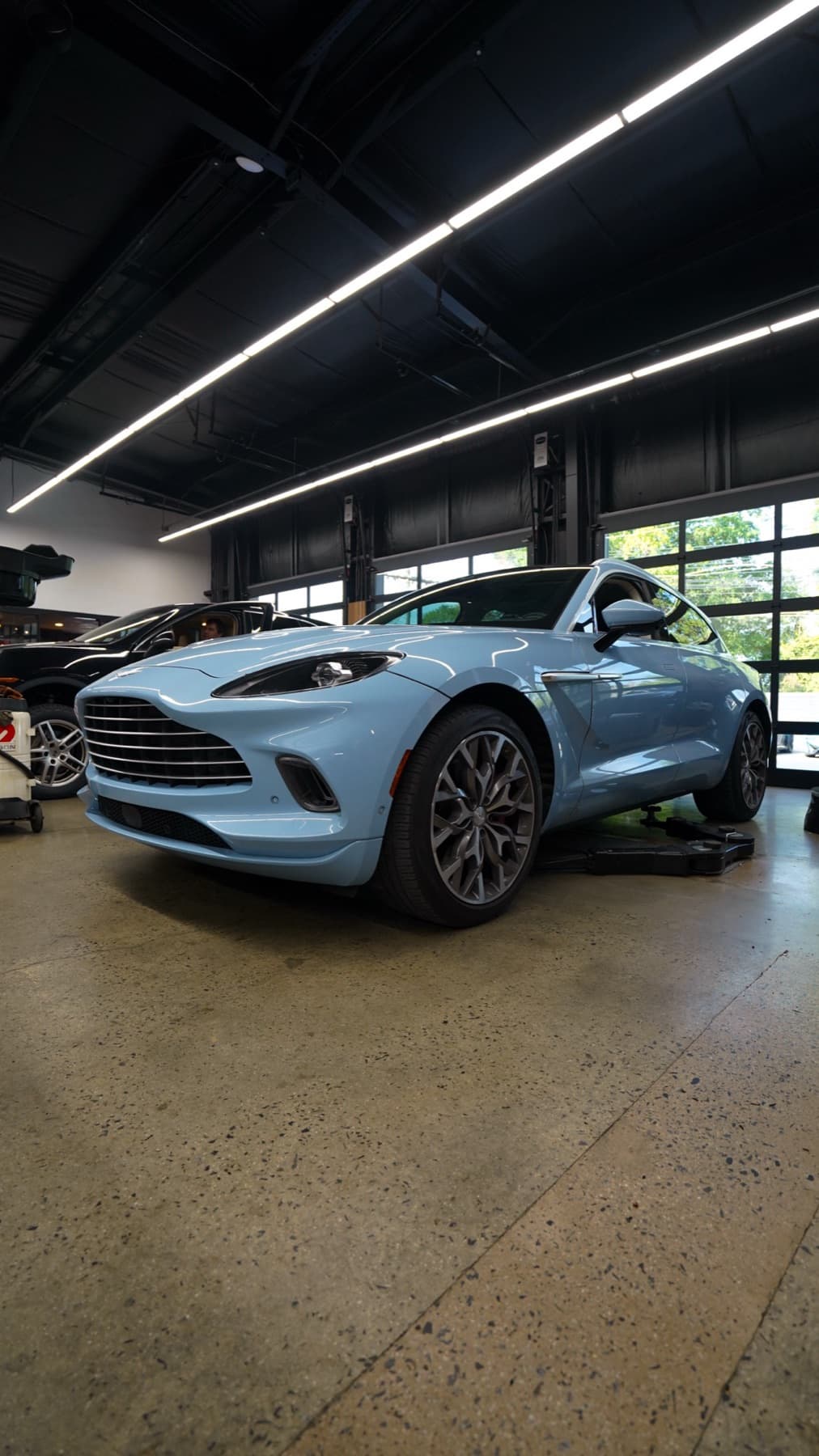 Light blue Aston Martin DBX on the shop floor