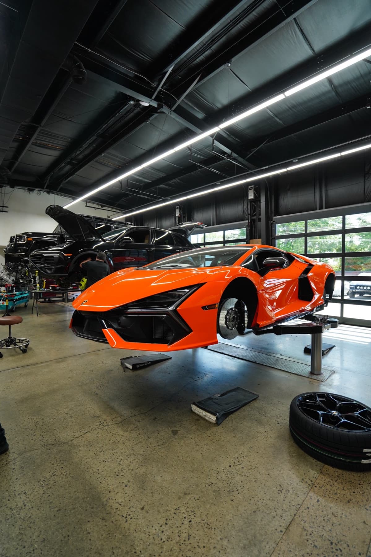 Orange McLaren raised on a lift