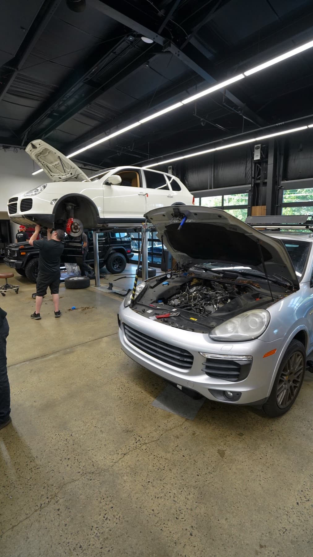 White Porsche Cayenne with its hood open