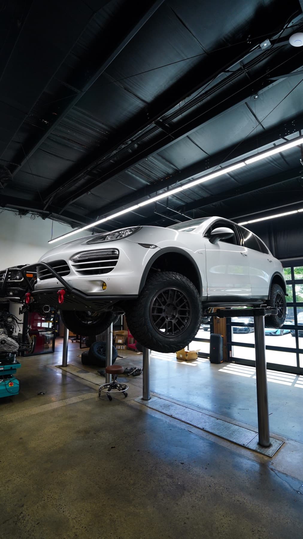 White Porsche 911 on a lift