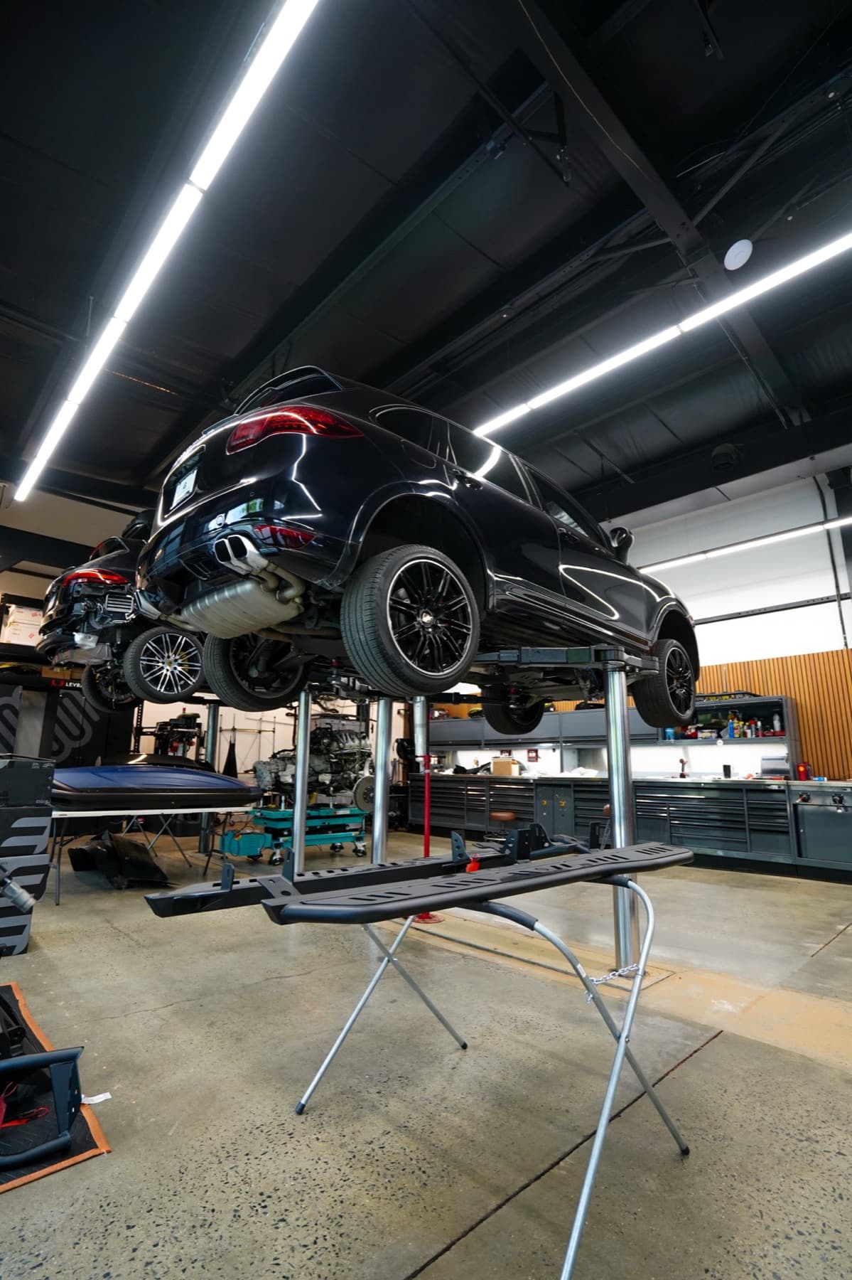 Black car raised on a lift