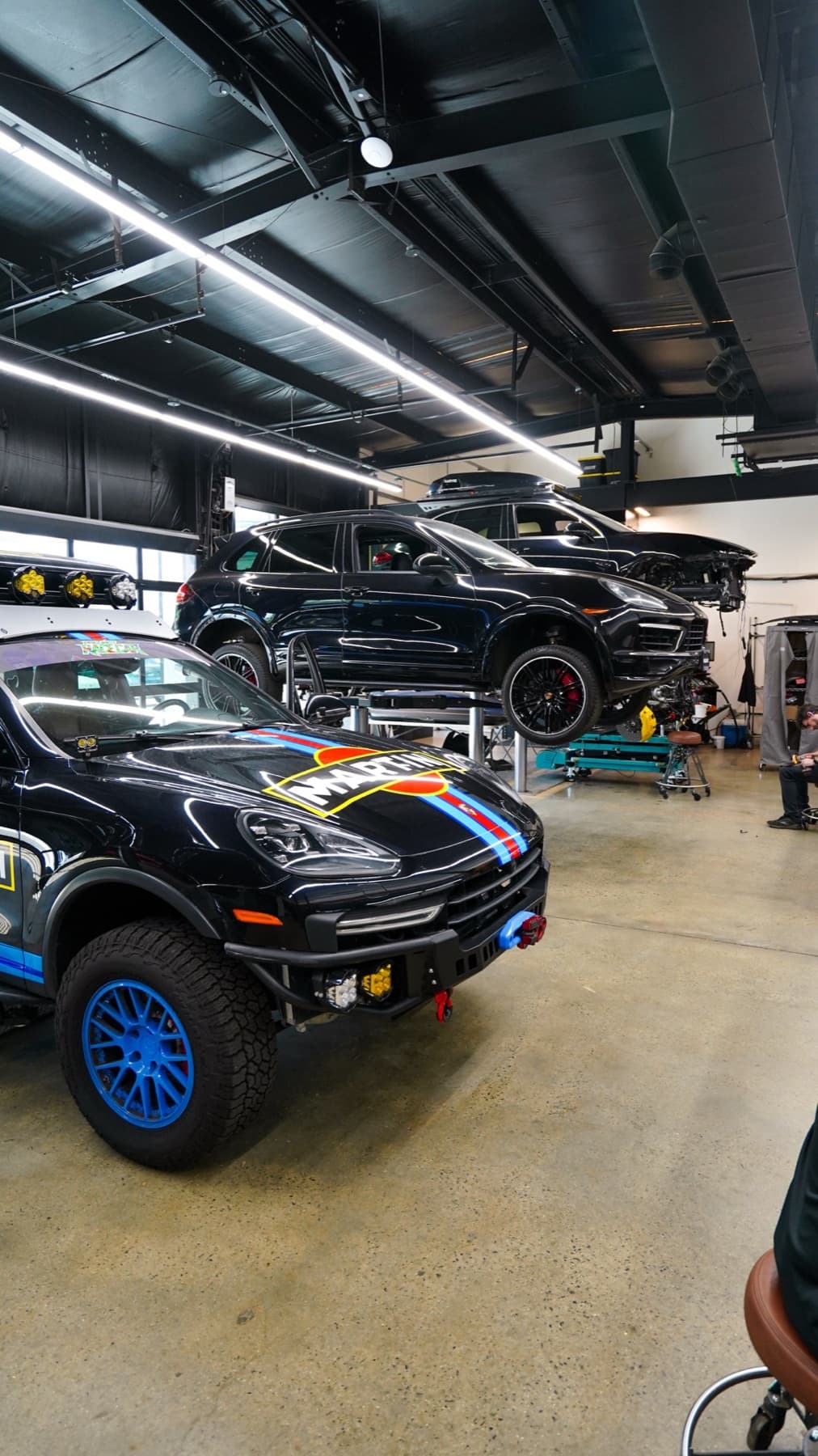Lifted Porsche Cayenne on blue off-road wheels