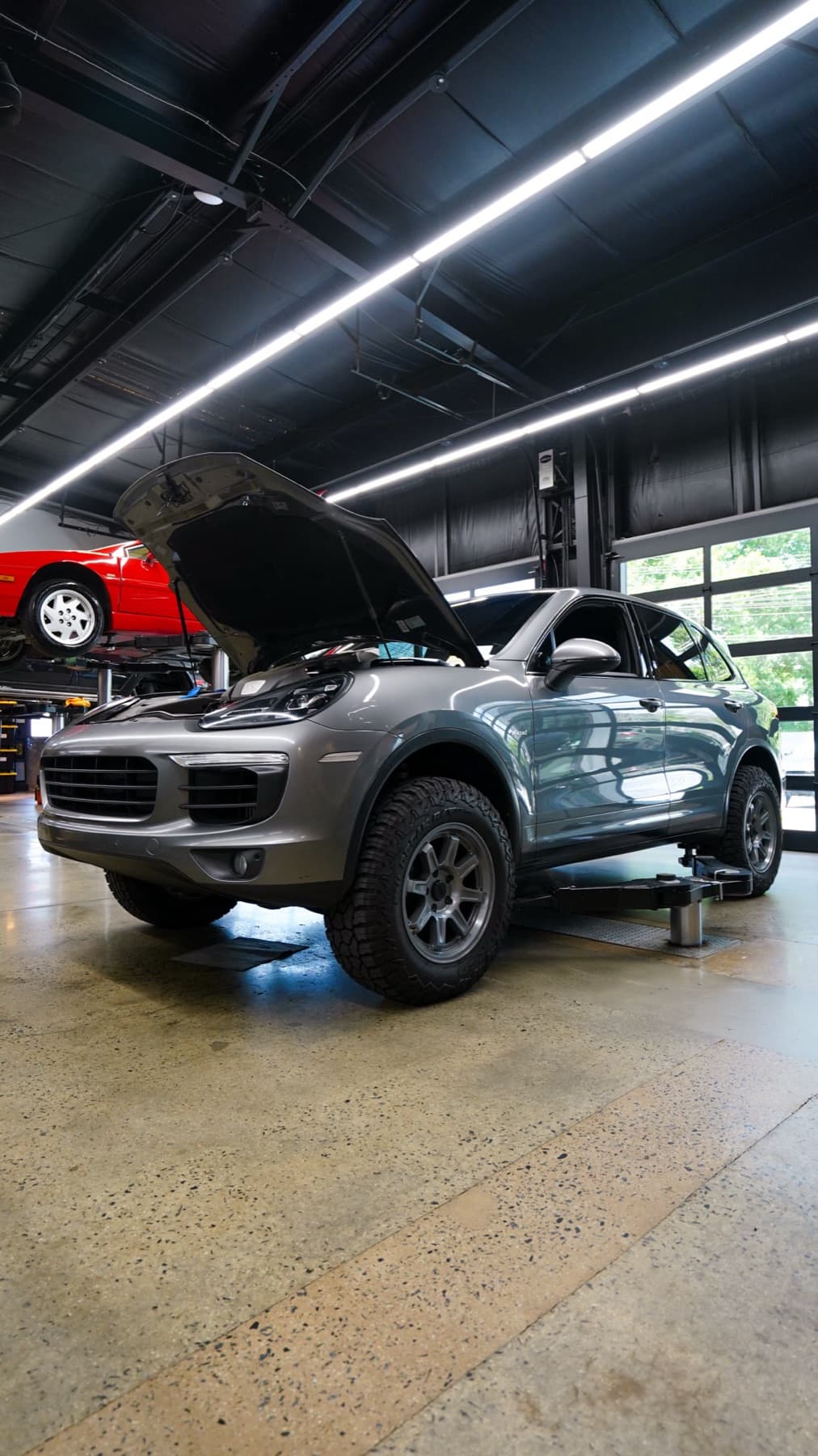 Silver Porsche Macan with its hood open