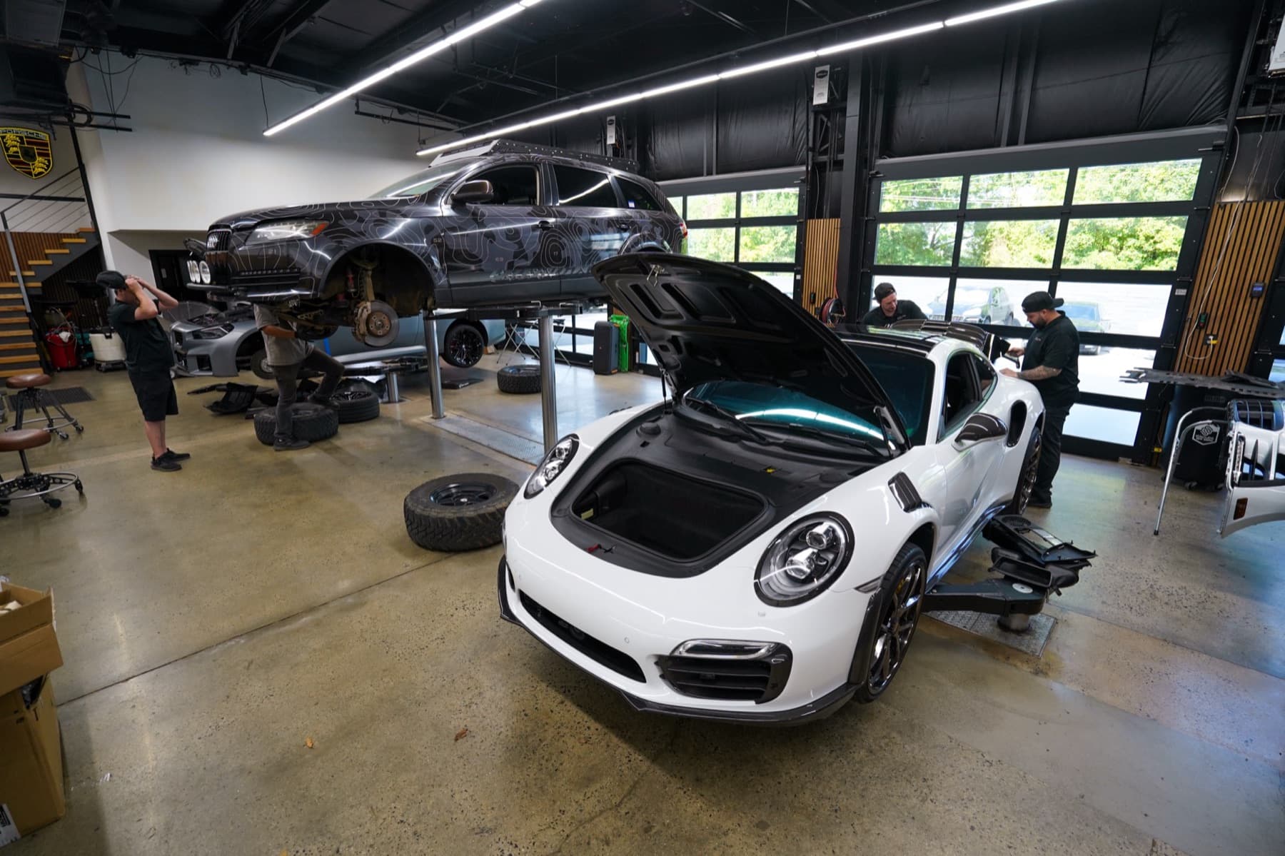 White Porsche 911 in the service bays