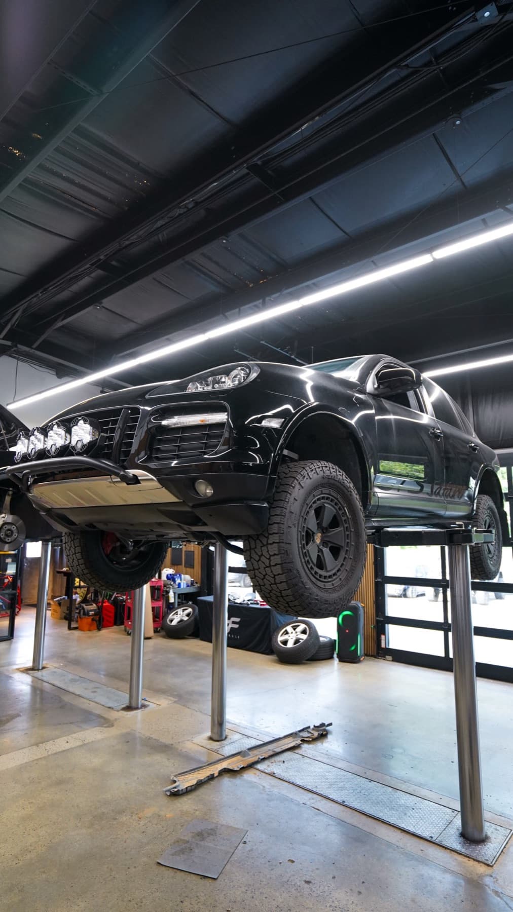 Dark SUV raised on a lift