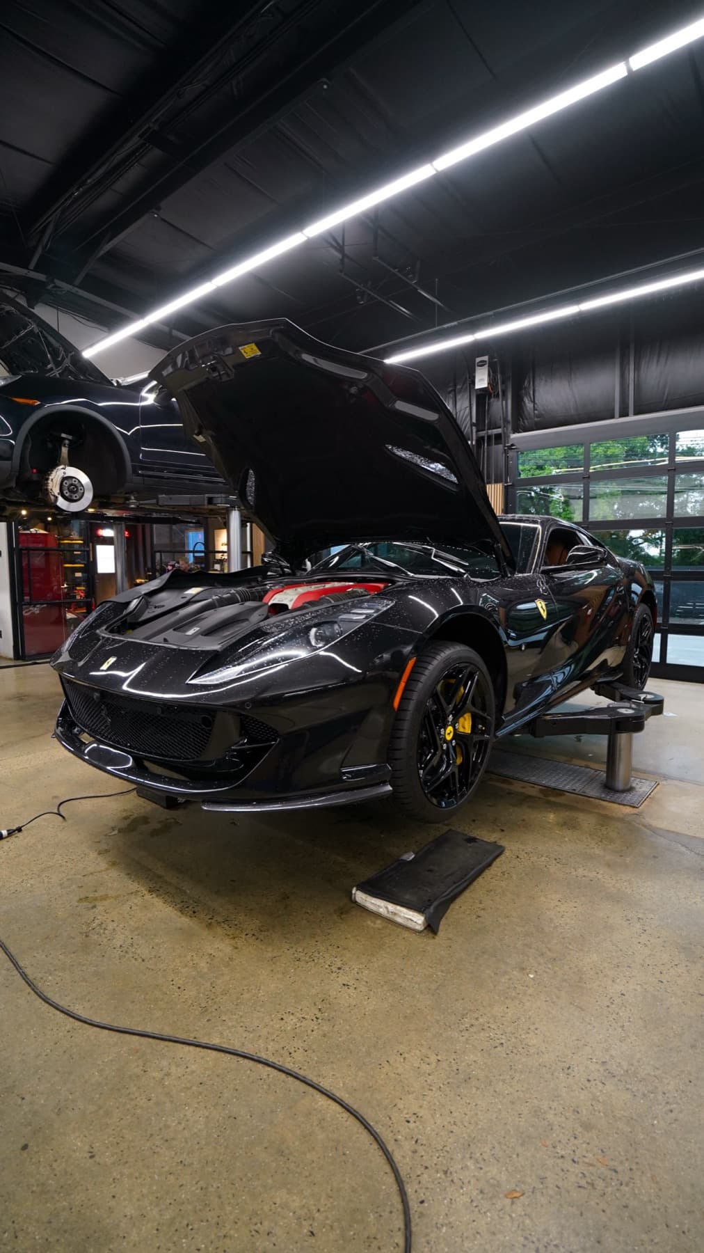 Black sports car with its hood open