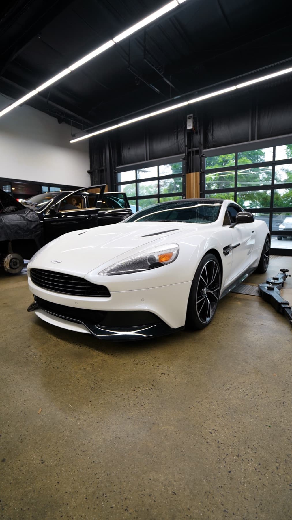White Aston Martin in the service bay