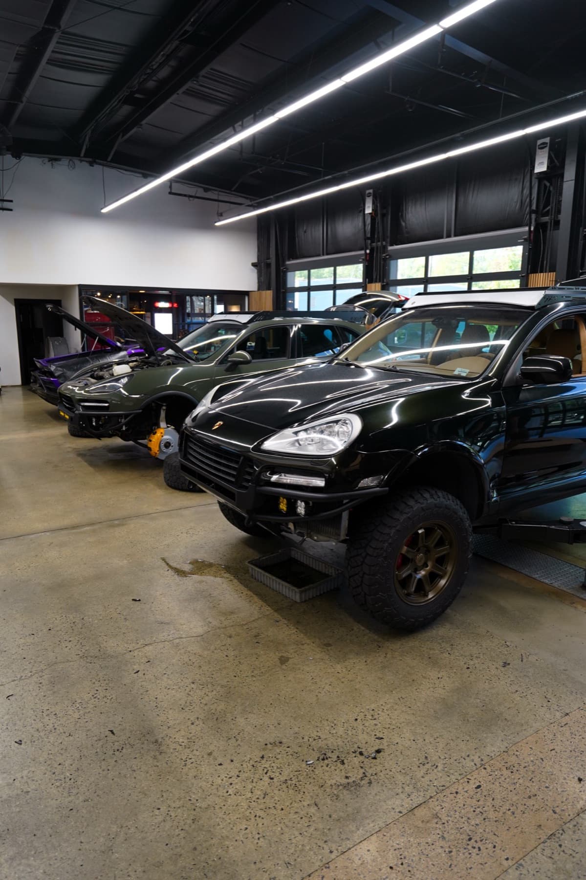 Dark off-road SUVs in the service bays
