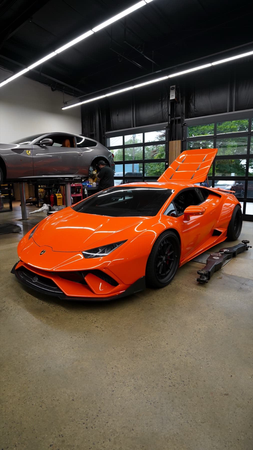 Orange Lamborghini Huracán with its hood open