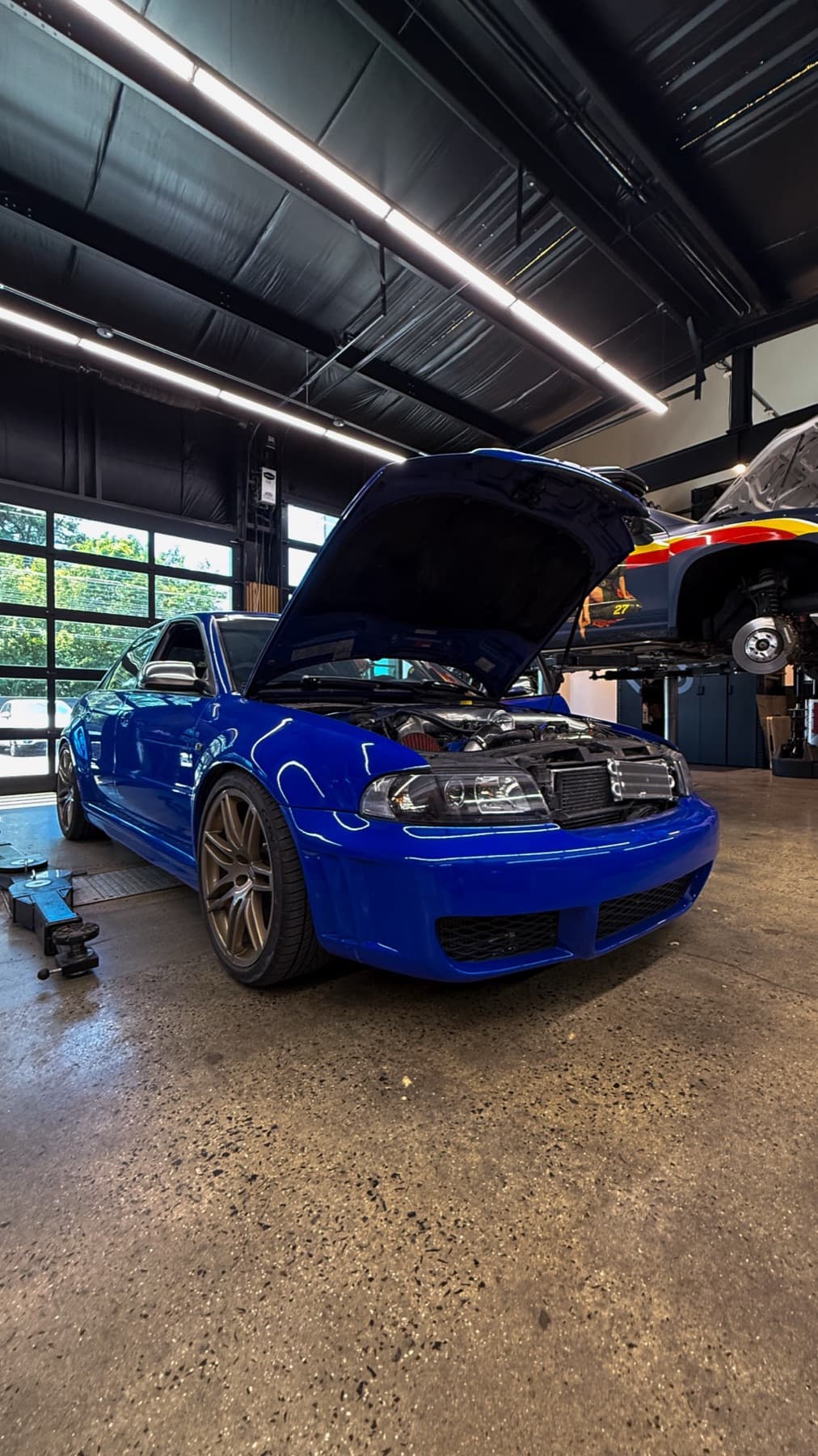 Blue car with its hood open
