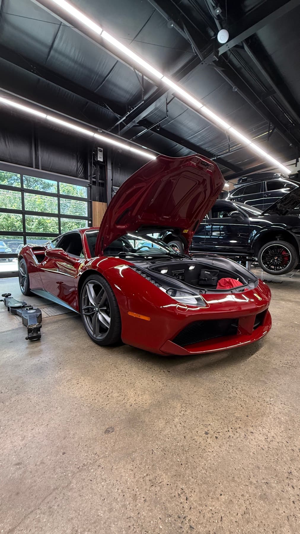 Red car with its hood open