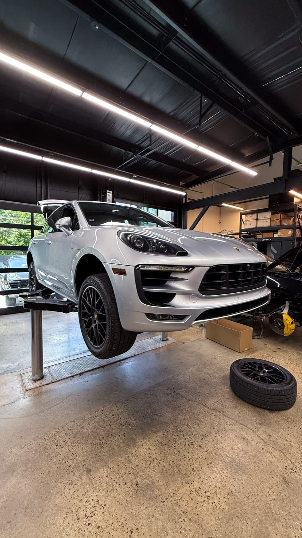 White Porsche Macan raised on a lift